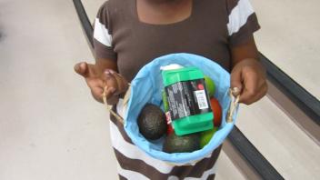 Child holding basket of fruits