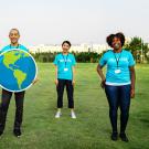 volunteers holding up an Earth poster