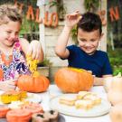 children carving pumpkins