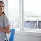 woman with yoga mat and health drink