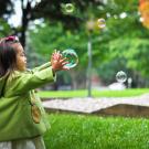 girl playing with bubbles